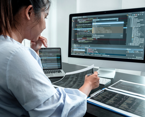 female developer programer working on coding software computer writing