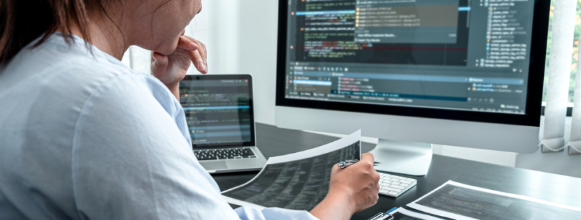 female developer programer working on coding software computer writing