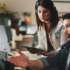people with headset talking and staring at the computer screen