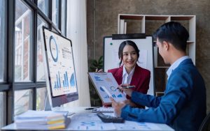 Young Asian business team creative businesspeople coworker in office. Meeting Presentation for tax analysis graph company financial. People Work in Business Office