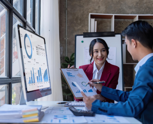 Young Asian business team creative businesspeople coworker in office. Meeting Presentation for tax analysis graph company financial. People Work in Business Office