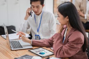 two payroll professionals working