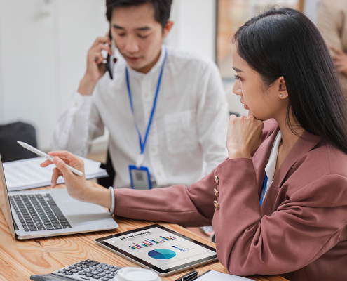 two payroll professionals working